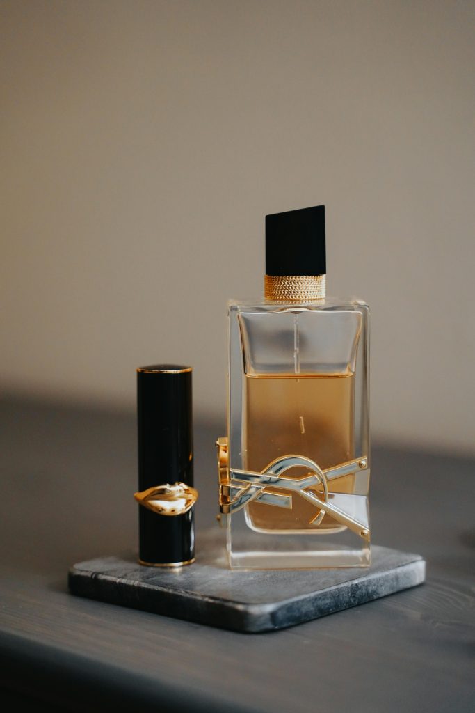A close-up of luxury perfume and lipstick showcasing elegance and style. Perfect for fashion and beauty themes.